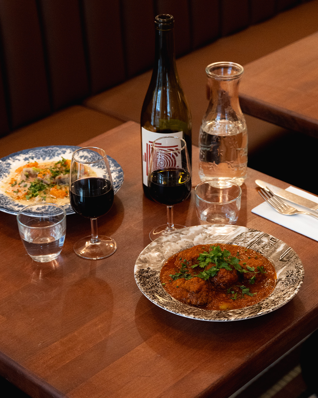 Plat mijoté servi avec du vin à La Mijoterie